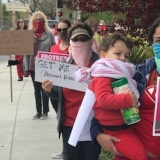 nurses holding signs