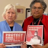 nurses holding signs