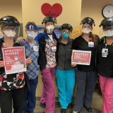 nurses holding signs