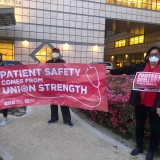 nurses holding signs