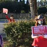 Nurses outside facility holding action