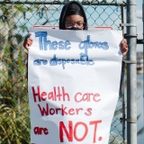 nurse holding sign