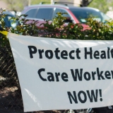 nurses holding signs