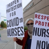 nurses holding signs