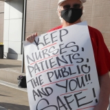 nurses holding signs