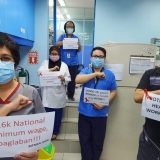 Filipino health workers in action for better wages and more protective equipment