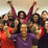 Large group of nurses with raised fists