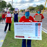 Nurse holds "Protect Nurses" signs