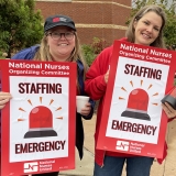 Asheville nurses hold signs that read "Staffing Emergency"