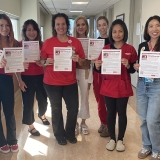 San Diego nurses hold flyers in support of prop. 50