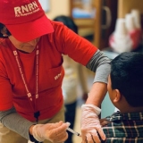 Nurse volunteering with RNRN
