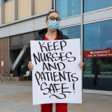 Nurses hold sign "Safe Nurses, Safe Patients"