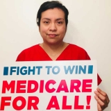 Nurse holding Medicare for All sign